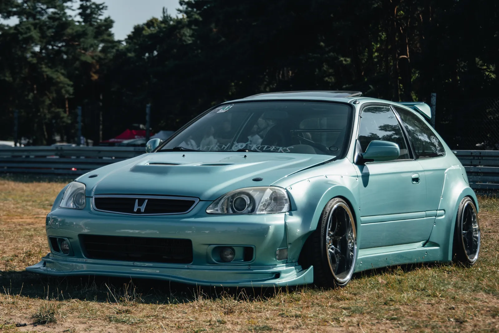 Blue modified Honda beside the track